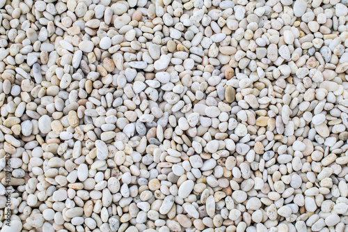 White rock river texture background. Abstract colorful mini granite crushed stones on ground texture background. Gray rubble construction rock pebble pattern