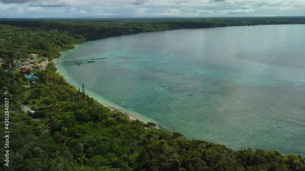 Aerial view around shallow water and a beach, on the Lifou Island - circling, drone shot Aerial view around shallow water and a beach, on the Lifou Island - circling, drone shot