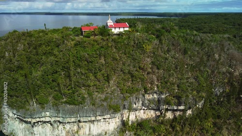 Aerial view of a hilltop Chapel, in Lifou, New Caledonia - circling, drone shot photo