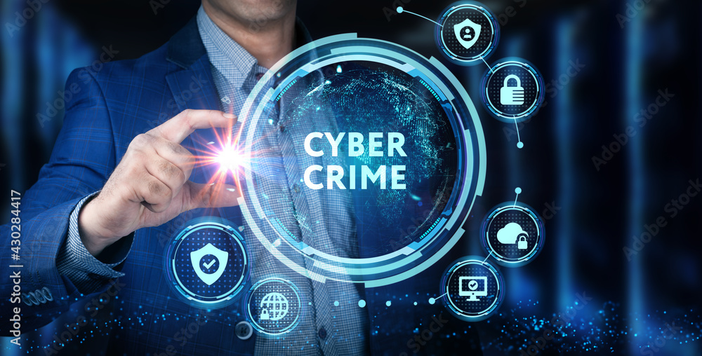 Fototapeta premium Cyber security data protection business technology privacy concept. Young businessman select the icon Cyber crime on the virtual display.