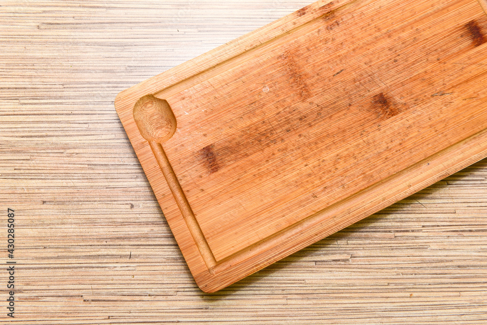 Old chopping board on wooden background top view Old chopping board on wooden background top view