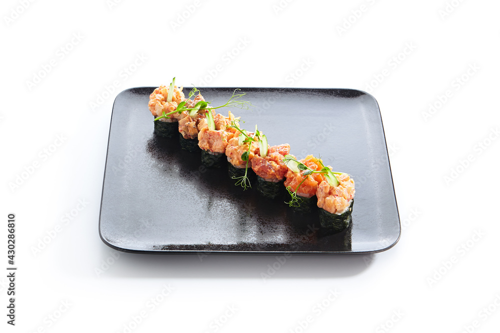 Gunkan Sushi - Gunkan Maki Sushi with Seafood and Spicy Sauce. Sushi with Rice inside and wrapped nori seaweed around. Delicious Gunkan Sushi on black slate plate. Isolated on white background. Gunkan Sushi - Gunkan Maki Sushi with Seafood and Spicy Sauce. Sushi with Rice inside and wrapped nori seaweed around. Delicious Gunkan Sushi on black slate plate. Isolated on white background.