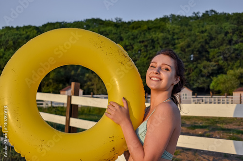 Happy girl in bikini with lifebuoy