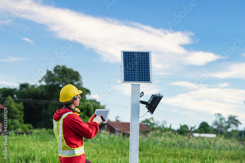 Photos Agronomists use a tablet computer to collect data with a tool, the solar cell system in the Smart Farm rice field