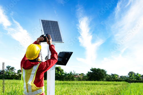 Agronomists use a tablet computer to collect data with a tool, the solar cell system in the Smart Farm rice field. photo