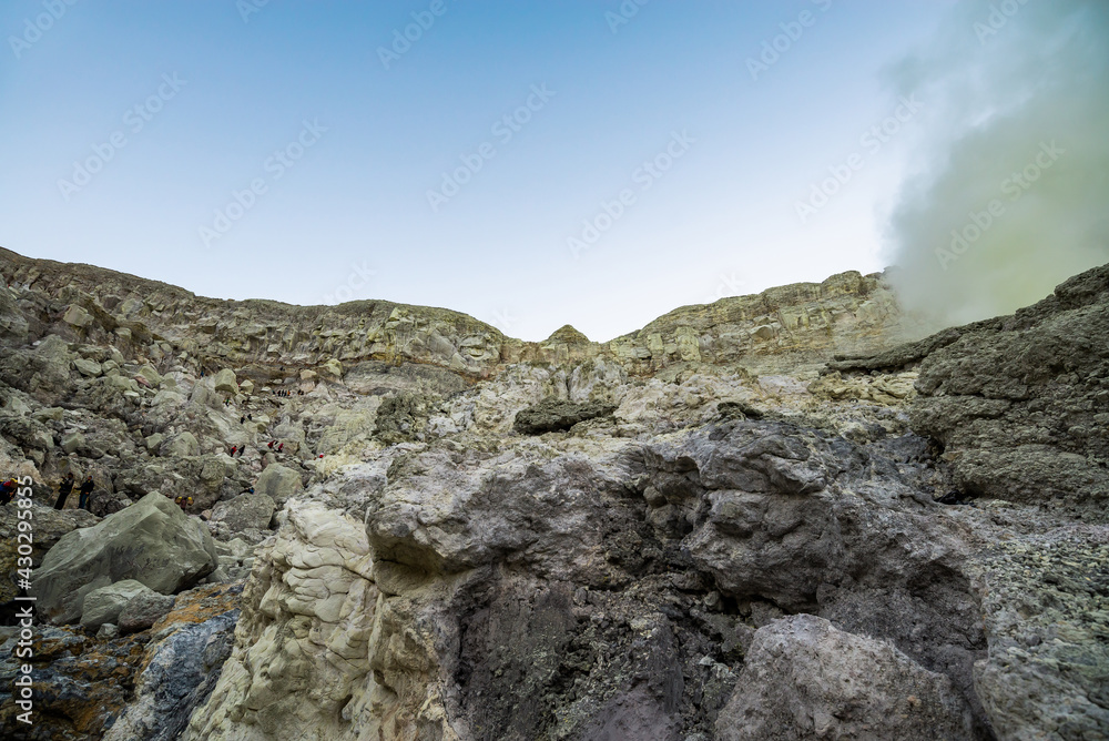 Rock wall and sulphur mining in Ijen crater in the morning in Kawah Ijen volcano Landmark from East Java Indonesia