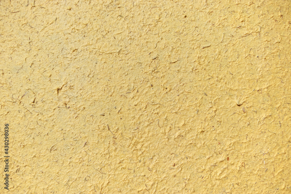 Yellow textured paper background made of elephant poo. Colorful natural material wallpaper and background. Eco friendly materials in sustainable concept. Yellow and textured cover and background. Yellow textured paper background made of elephant poo. Colorful natural material wallpaper and background. Eco friendly materials in sustainable concept. Yellow and textured cover and background.