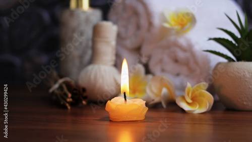 Candle light of Spa accessories,Beautiful composition of spa , spa relax concept, herbs for massage, beautiful sap set on wood table,Dark tone