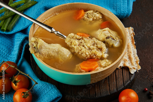 Soup with matzo dumplings and chicken with carrots and tomatoes. Healthy Food for Passover photo