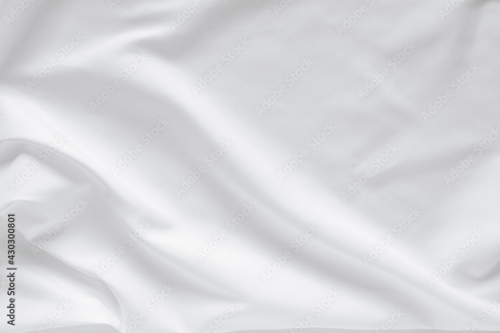 Fototapeta premium Abstract white fabric texture background. Cloth soft wave. Creases of satin, silk, and cotton.