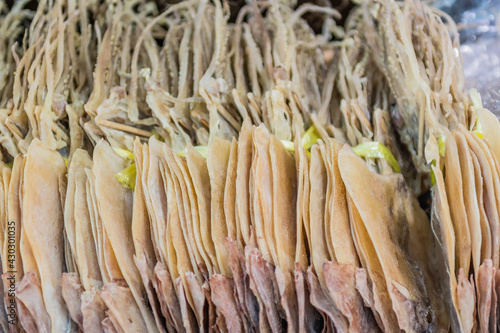 Dried squid on display for sale at seaside fish market.