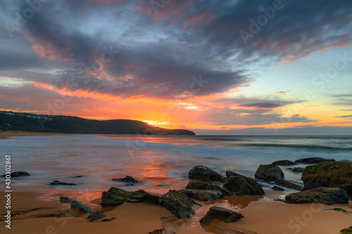 Sunrise at the seaside with pastel coloured clouds