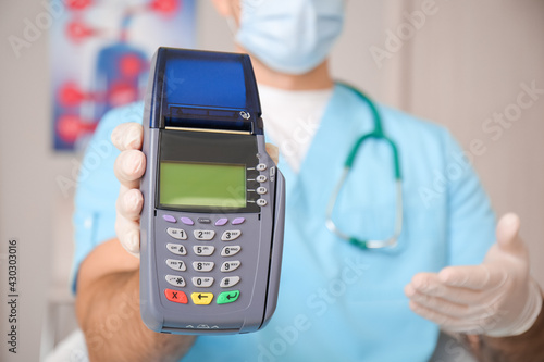 Doctor with payment termina...