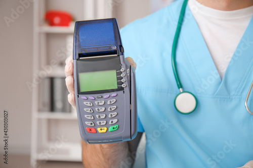 Doctor with payment termina...