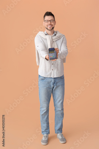 Man with payment terminal o...