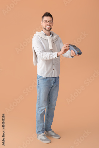 Man with payment terminal o...