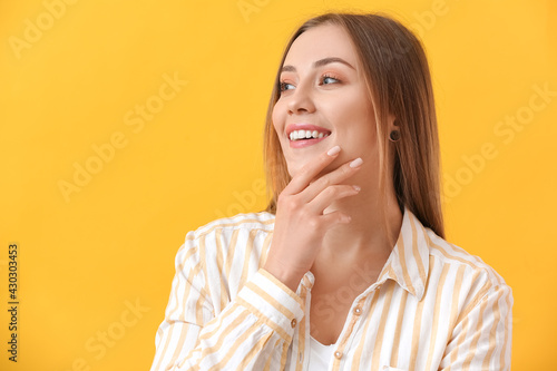 Young woman with beautiful manicure on color background