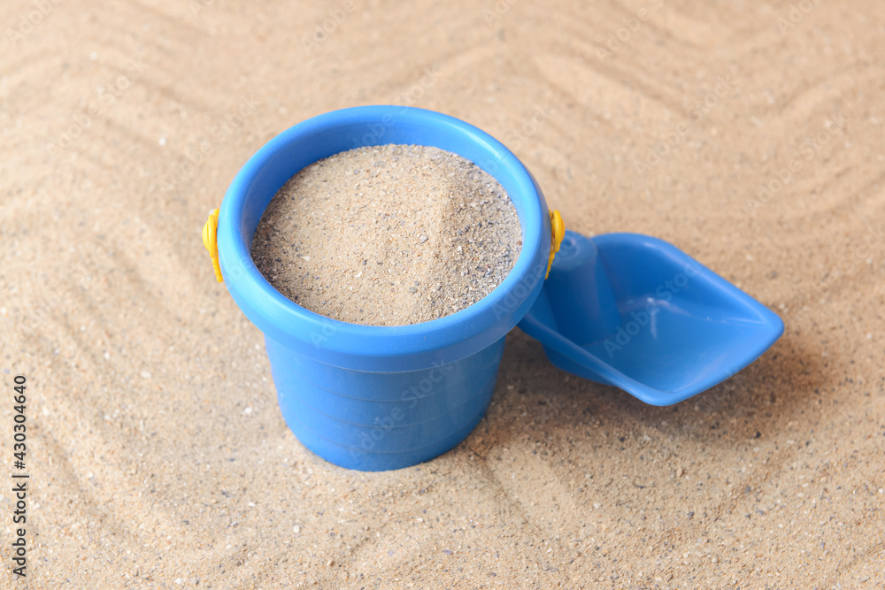 Toy bucket and shovel for children on sand Toy bucket and shovel for children on sand
