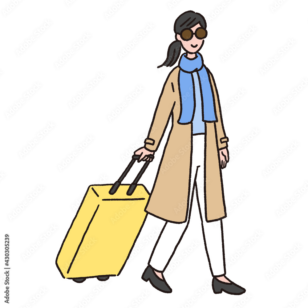 スーツケースを持って歩いている若い女性