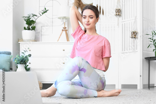 Young woman practicing yoga...