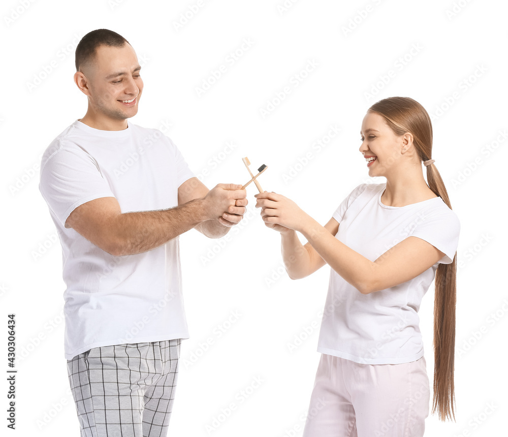 Young couple brushing teeth on white background Young couple brushing teeth on white background