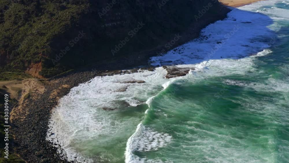 Foamy Sea Waves Washing Rocky Shore At Royal National Park In New South Wales, Australia - aerial shot Foamy Sea Waves Washing Rocky Shore At Royal National Park In New South Wales, Australia - aerial shot