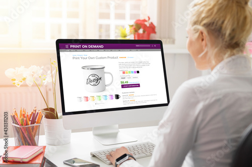 Woman creating her own products online by using print on demand service photo