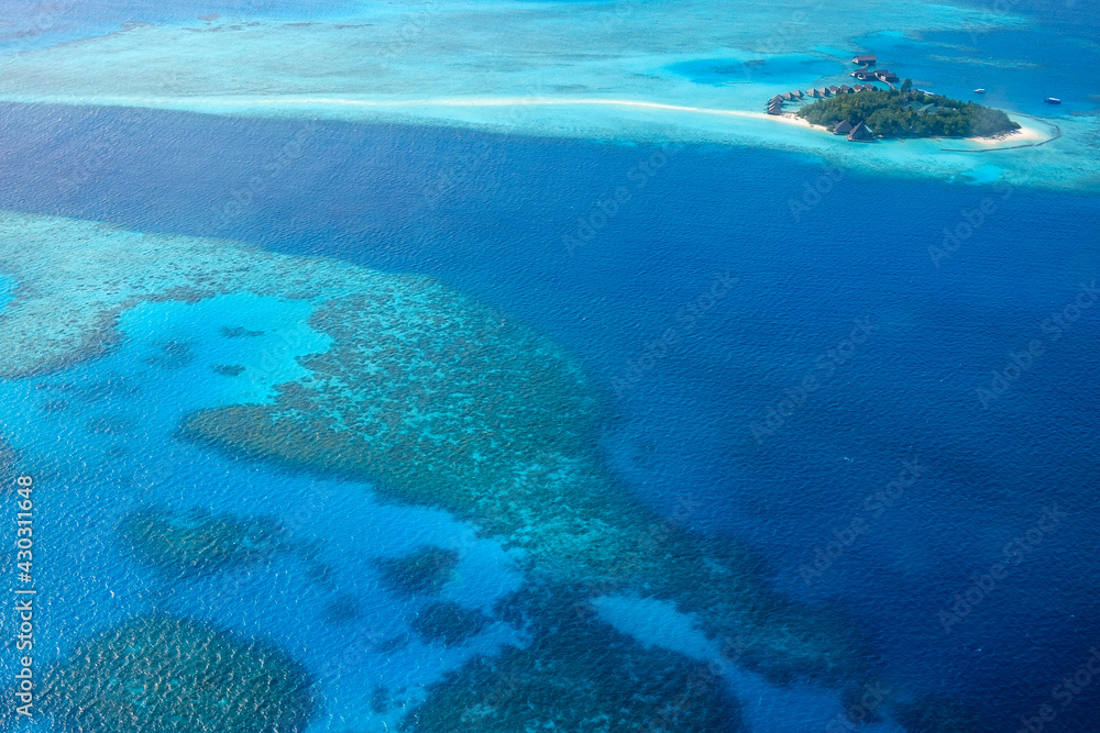 Aerial view of a resort on a coral atoll in the Indian Ocean