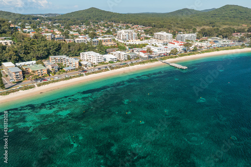 Aerial view of Shoal Bay foreshore, wharf and town, and beautilful aqua waters photo