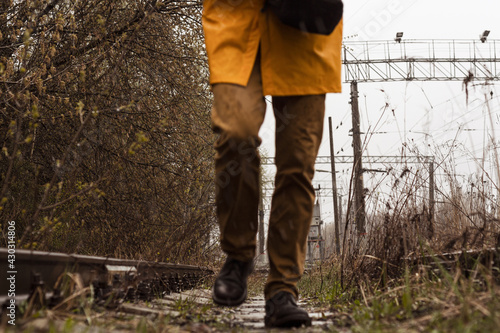 Yellow cloak, forest. A man in a yellow raincoat, cold and wet weather.