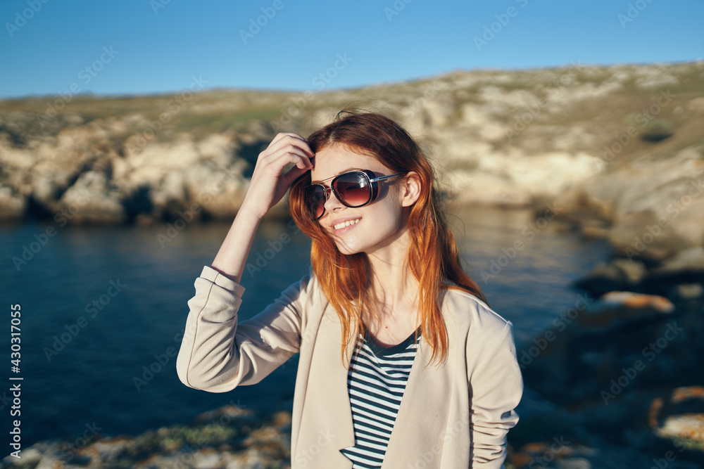 woman hiker in t-shirt glasses on nature in the mountains fresh air sea lifestyle woman hiker in t-shirt glasses on nature in the mountains fresh air sea lifestyle