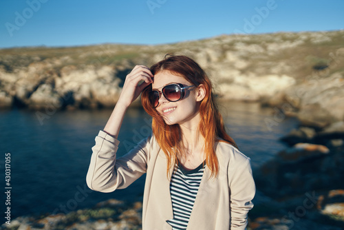 woman hiker in t-shirt glasses on nature in the mountains fresh air sea lifestyle
