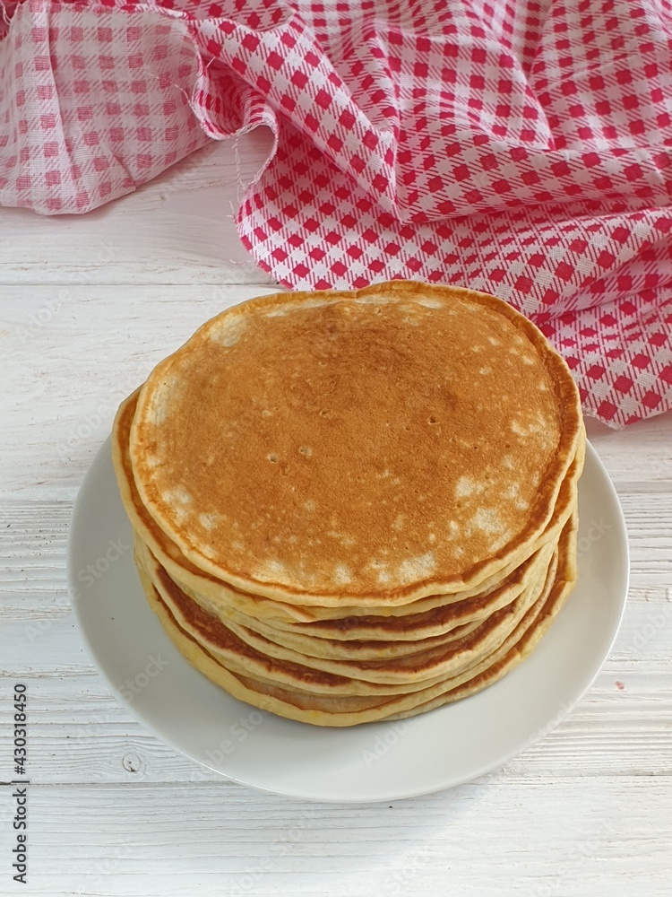 Pancakes with strawberries and mint on a white background Pancakes with strawberries and mint on a white background