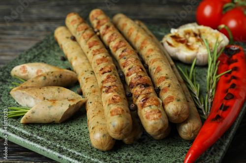 Concept of tasty food with grilled sausage on wooden table
