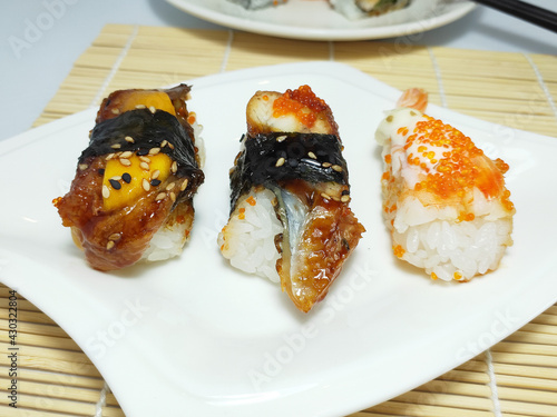 Three different flavors of sushi, salmon, fish roe, black sesame, close-up