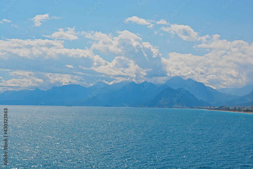 blue sky with clouds with mountains with sea 