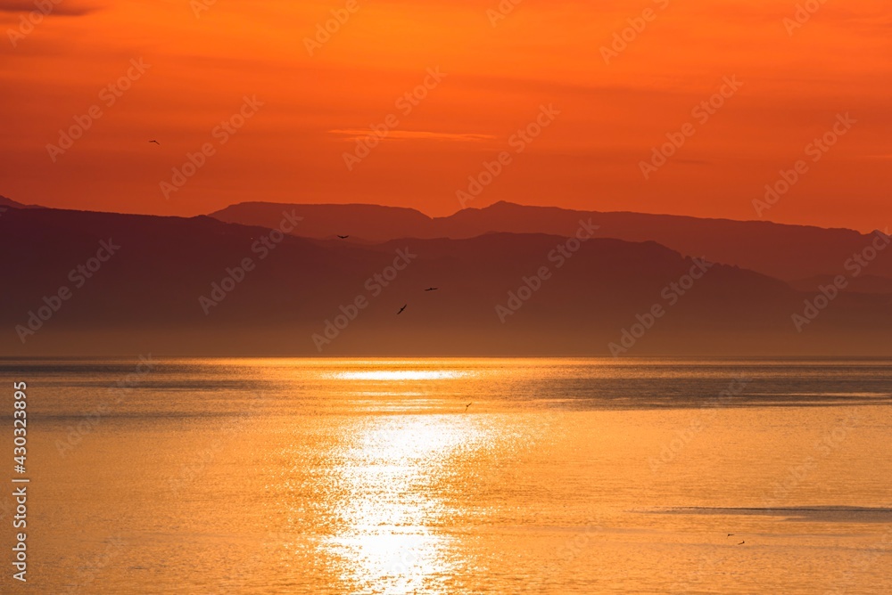 Beautiful sunrise by the sea, hazy morning, Golden water 