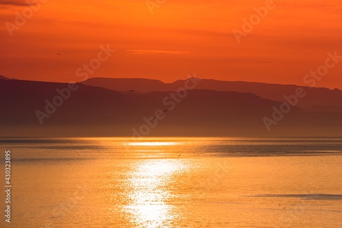 Beautiful sunrise by the sea, hazy morning, Golden water 