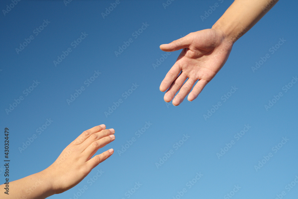 Close-up of hands drawn to each other on blue background, friendship, help