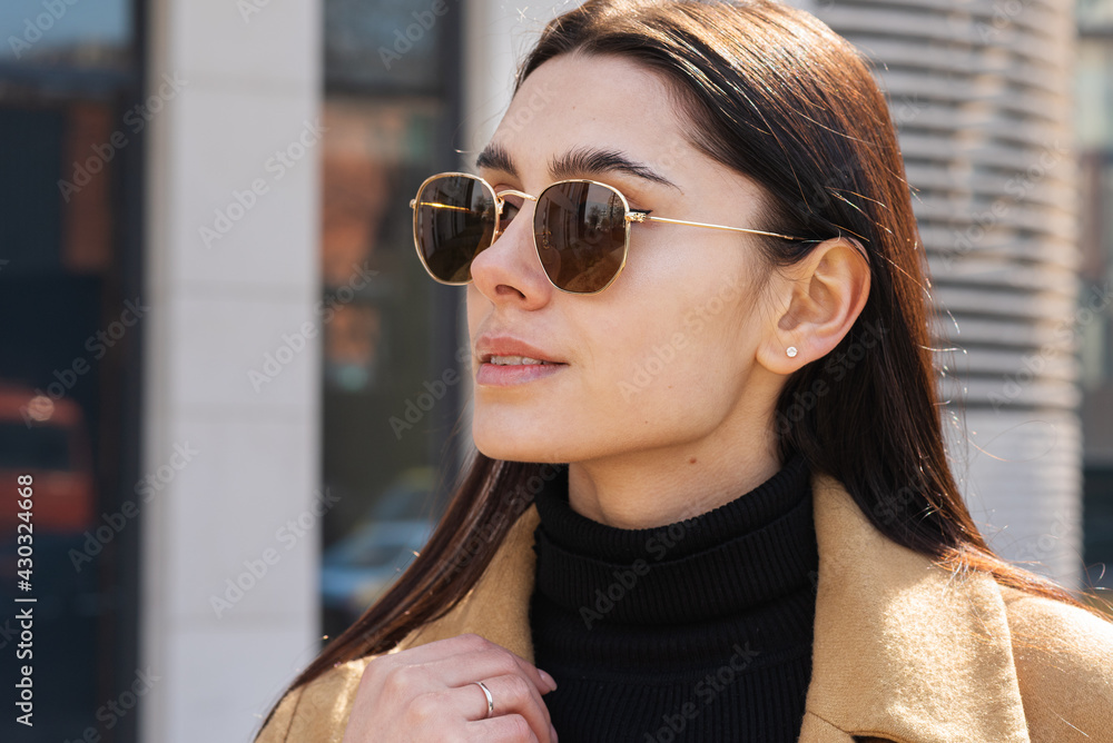 Close-up of the face of a beautiful young woman in sunglasses outdoors Close-up of the face of a beautiful young woman in sunglasses outdoors