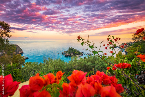 Purple cirrus clouds over the sea and Isola Bella in Taormina, Sicily 