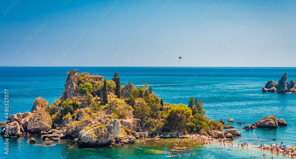Parachuting over the beautiful Island Isola Bella in Taormina, Sicily 