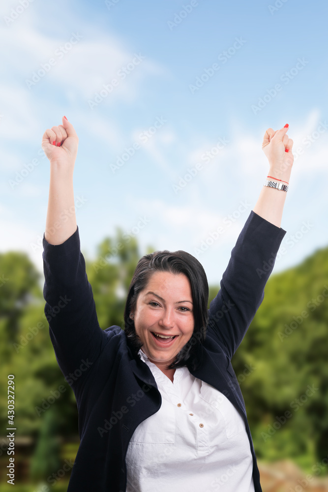 Cheerful businesswoman making celebrating gesture and expression Cheerful businesswoman making celebrating gesture and expression