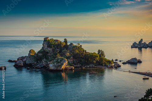 Warm sunset sky over the small island of Isola Bella in Taormina, Sicily 
