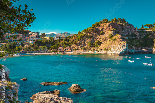 Marvelous sunny beach (Isola Bella) on the coast of Taormina, Sicily. Crystal clear turquoise water on the beach of Isolabella, Taormina photo