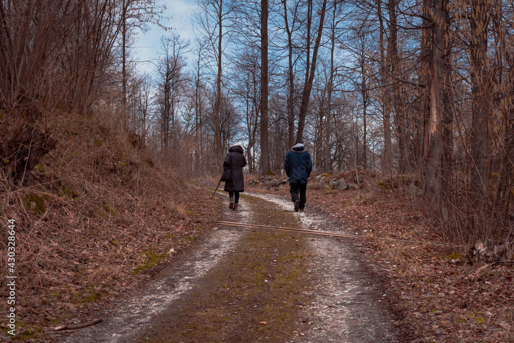 Couple walking on the path on the mountain forest Couple walking on the path on the mountain forest