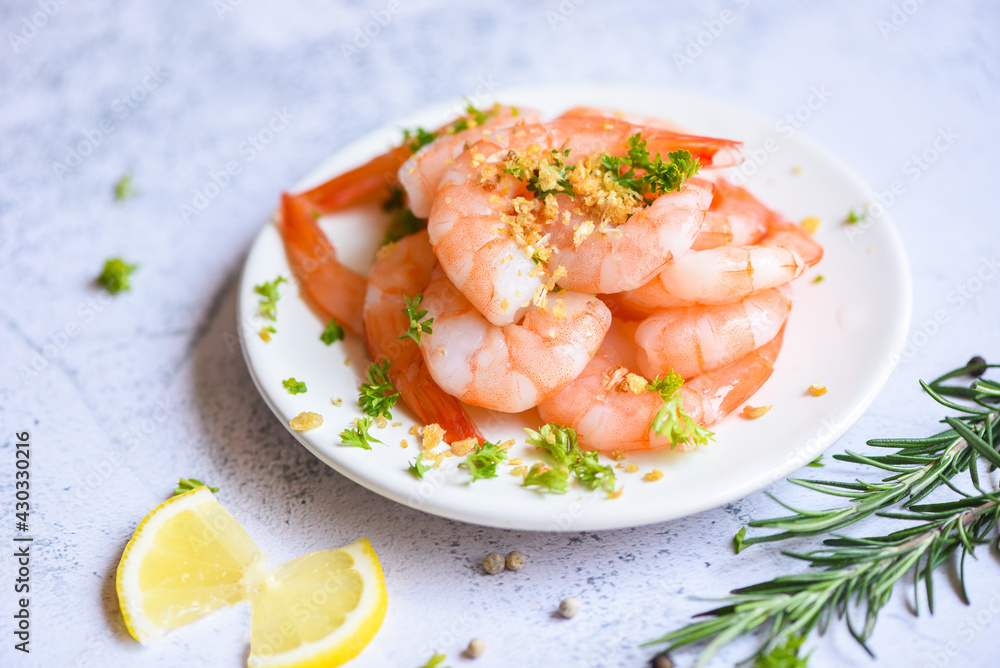 fresh shrimps served on white plate in the seafood restaurant, boiled shrimp prawns cooked with herbs and spice