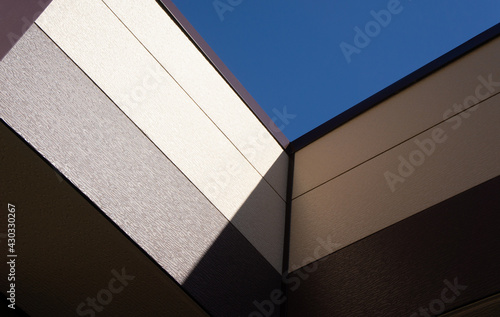 geometric abstraction brown wall shadow and sky