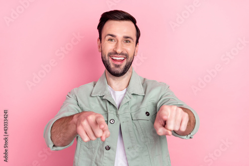 Photo of nice optimistic brunet man point you wear grey shirt isolated on pastel pink color background