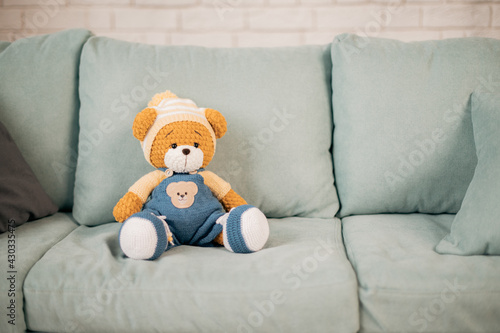 knitted toy bear on the couch